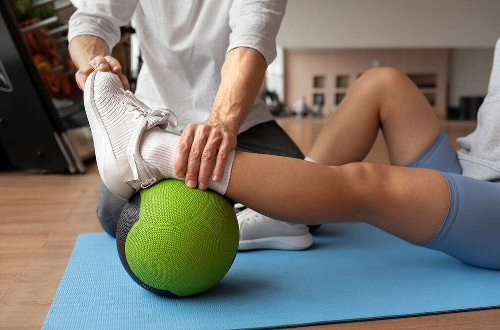 athlete with ankle pain at clinic