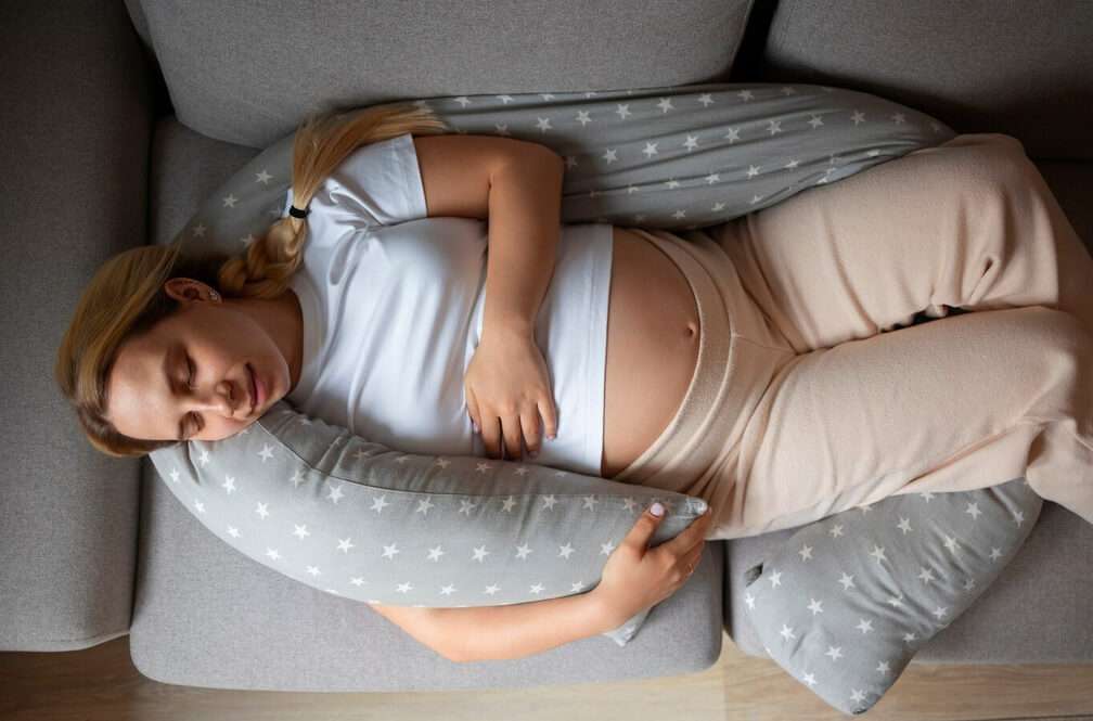 pregnant woman laying on the bed