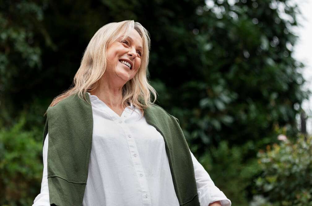 woman in her 60s standing outside