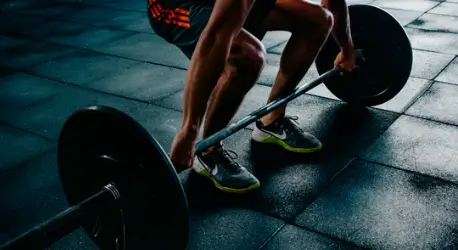athlete lifting weight in the gym