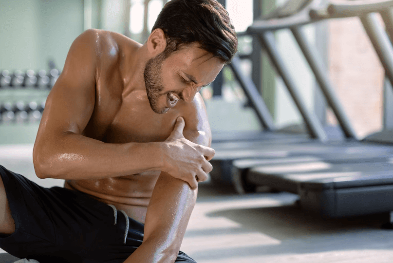 man with shoulder pain in gym