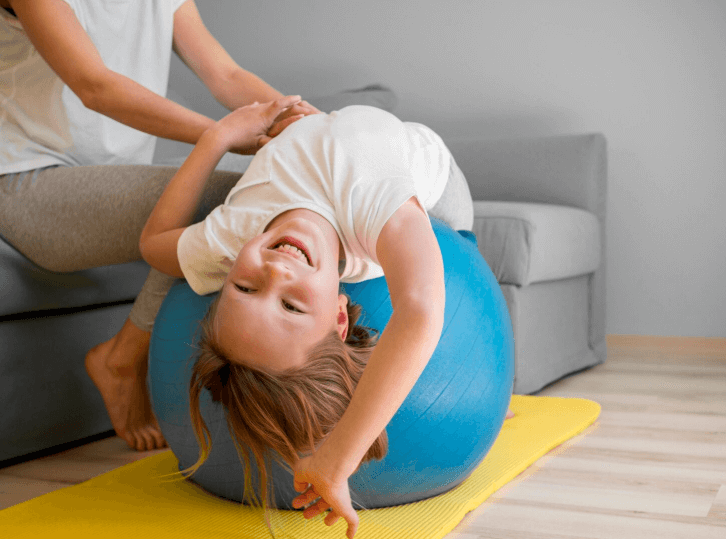 gril laying back down on pilates ball
