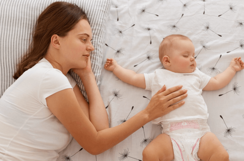 mom with baby in bed